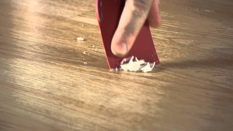 close shot of a scrubber removing wax from hardwood floor.